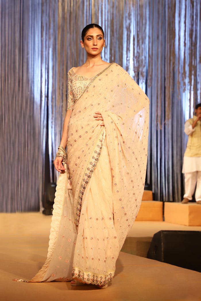 Model in traditional Indian sari at fashion event in Faridabad, India. Perfect for cultural fashion themes.