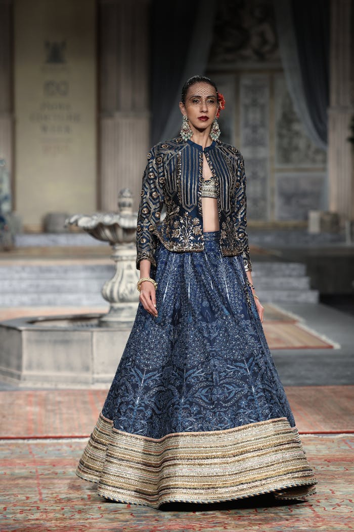 Indian model in traditional attire on a fashion week runway in New Delhi. Glamorous and stylish.
